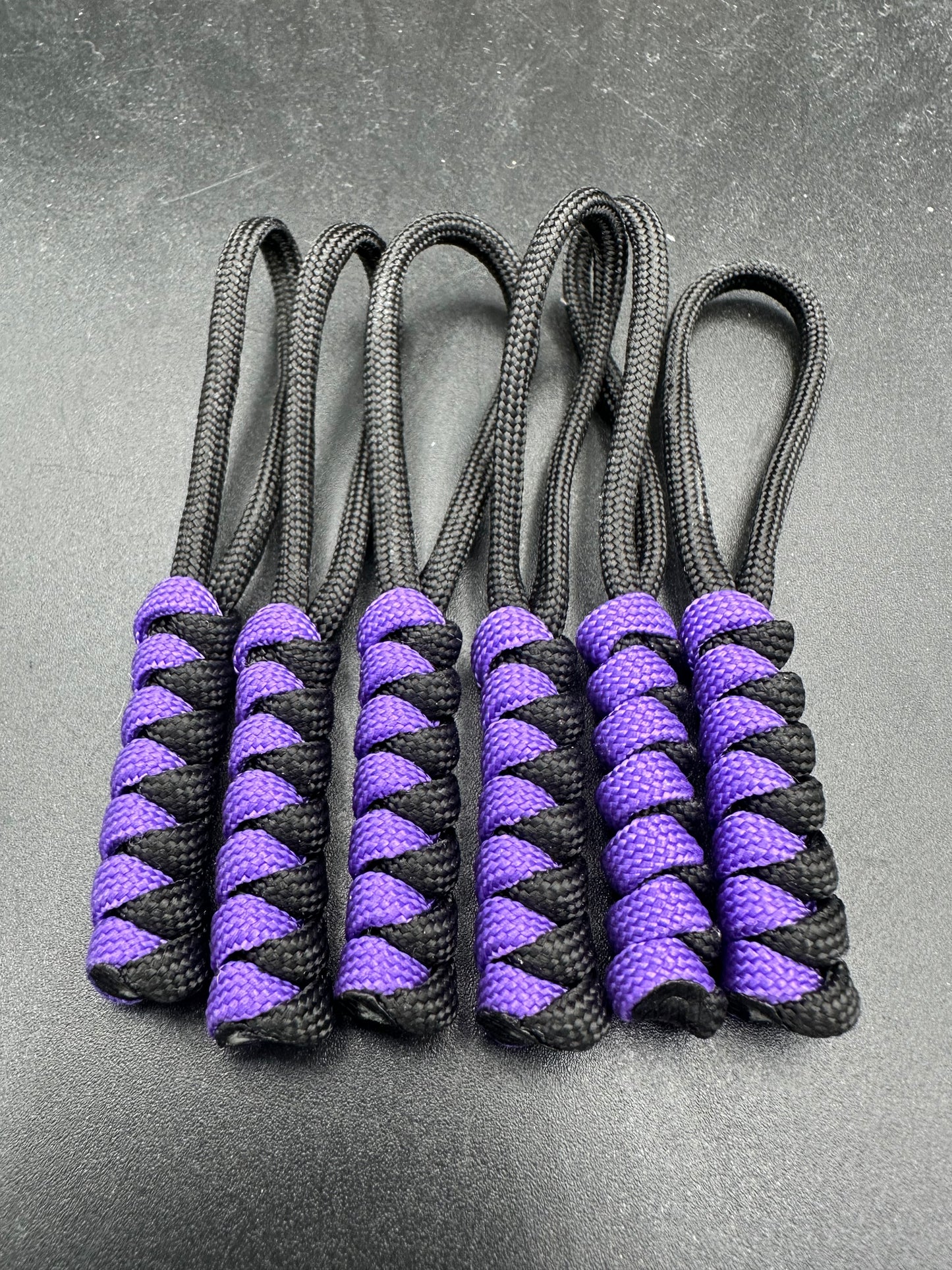 Paracord zip pulls in a Halloween themed black & purple Sold as a 6 pack theses are light weight, strong and all handmade in our U.K. store