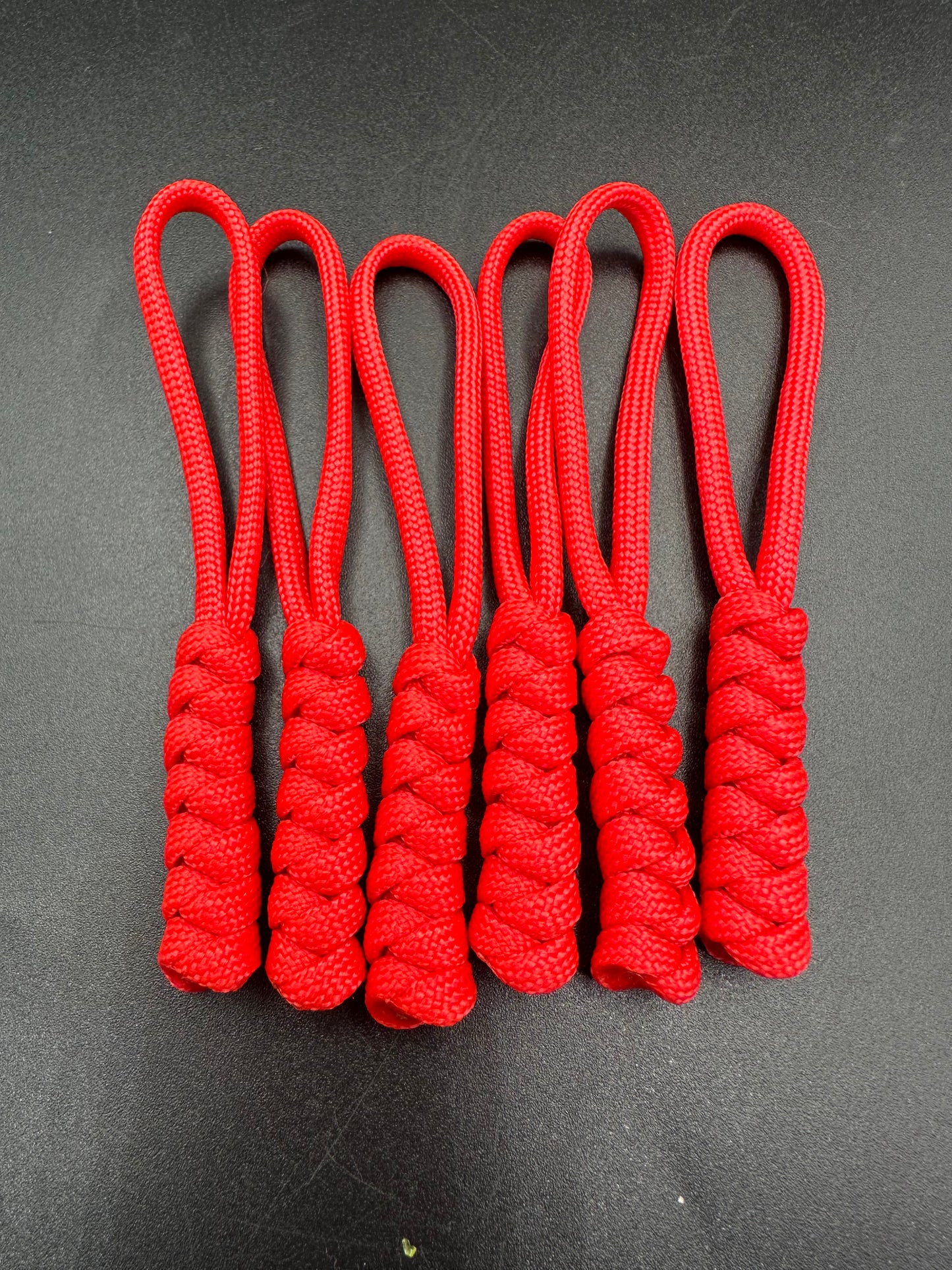 Paracord zip pulls in a Halloween themed red
Sold as a 6 pack theses are light weight, strong and all handmade in our U.K. store