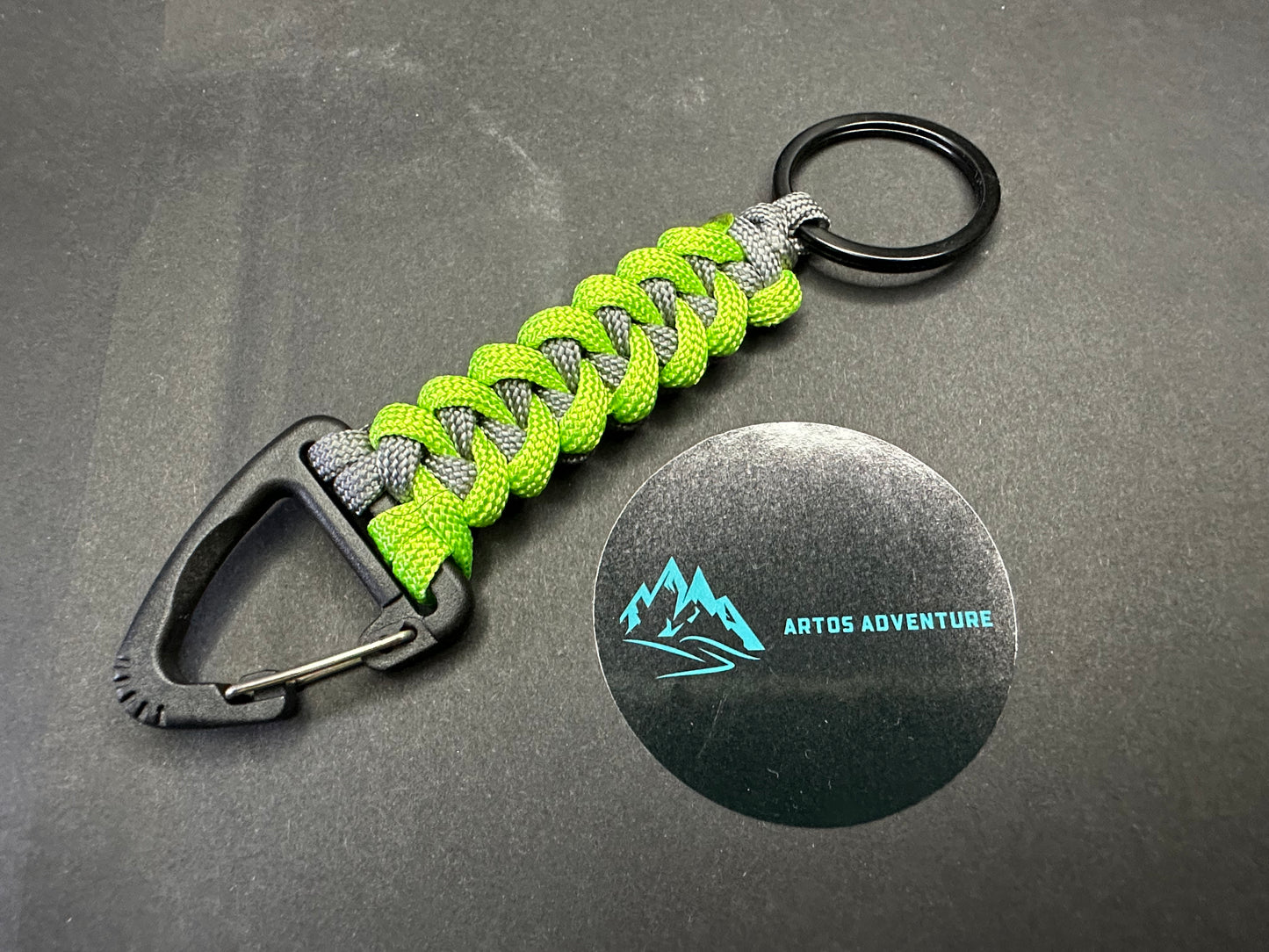 Tactical EDC Paracord keyring with a triangle clip and split ring, made in grey and neon green coloured shark jaw weave