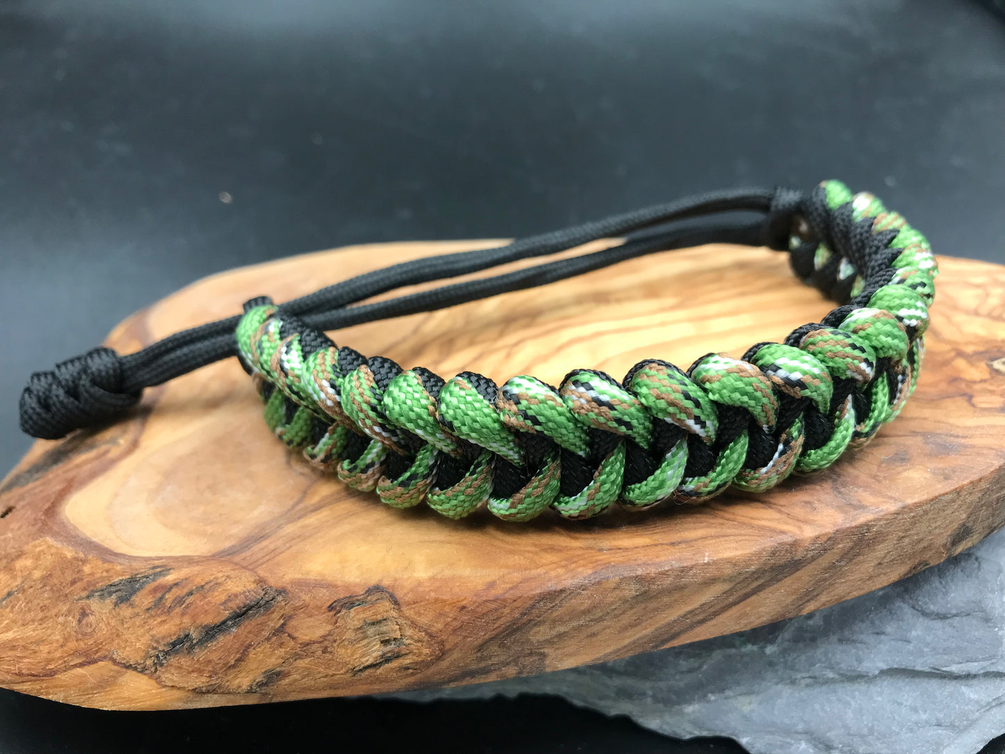 Paracord survival bracelet hand made lightweight and in black and forest green camo coloured Paracord U.K.