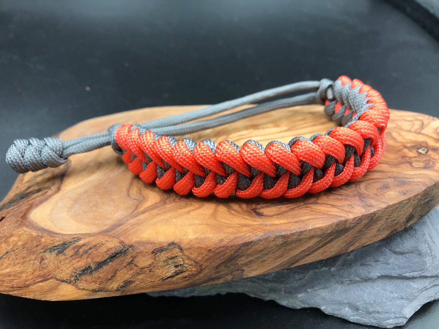 Paracord survival bracelet hand made lightweight and in grey and neon orange coloured Paracord U.K.
