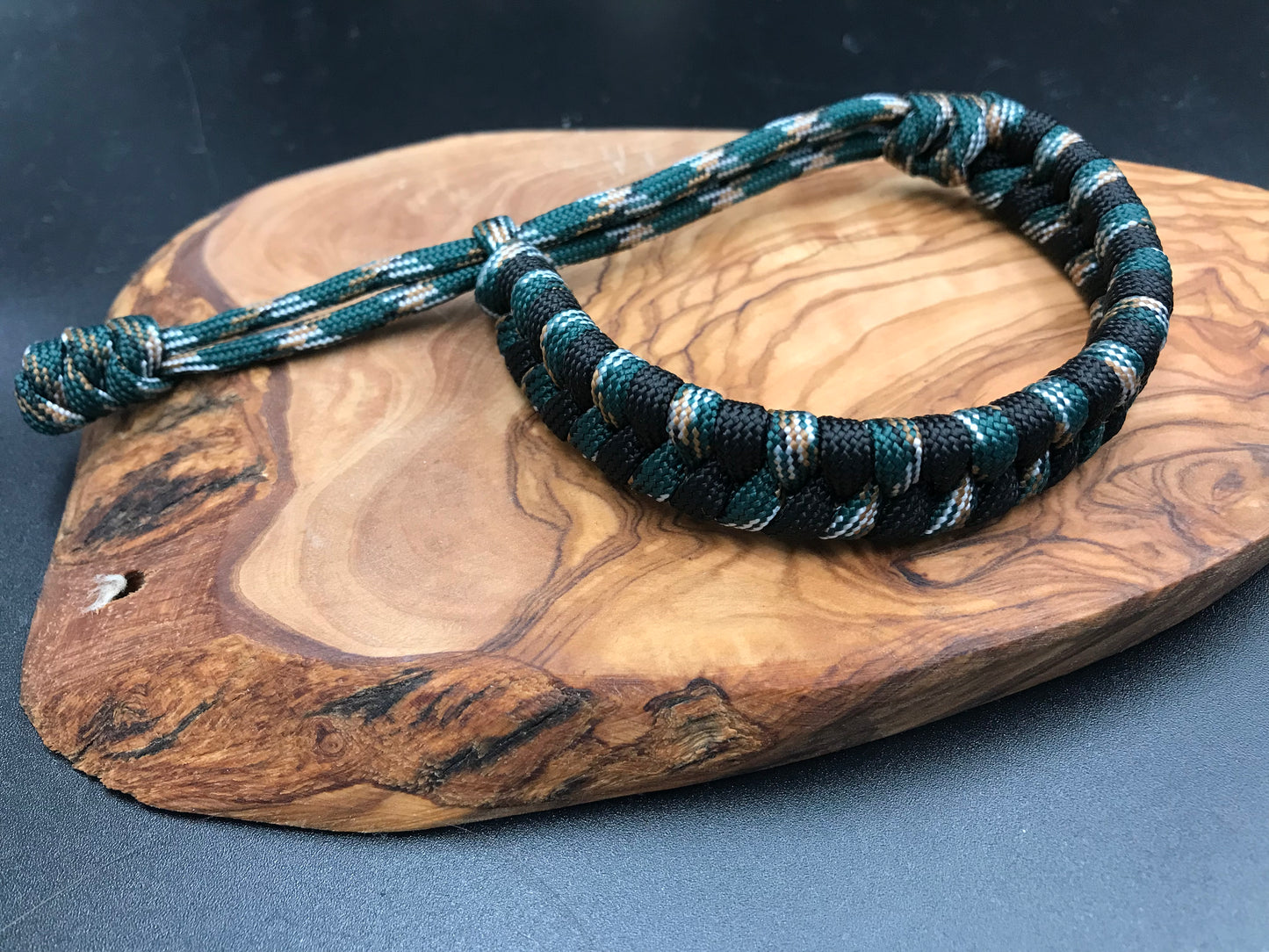 Handmade Paracord Fishtail weave bracelet in Urban camo (dark greens grey and white) and black for the tactical striped pattern look