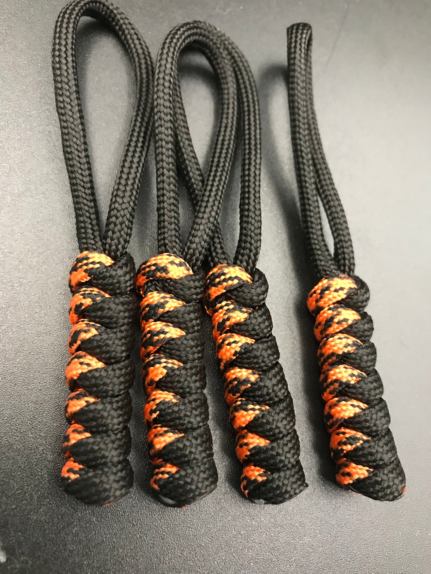Paracord zip pulls in black & tiger orange ( black/orange mix ) (4 pack) hand made in U.K.