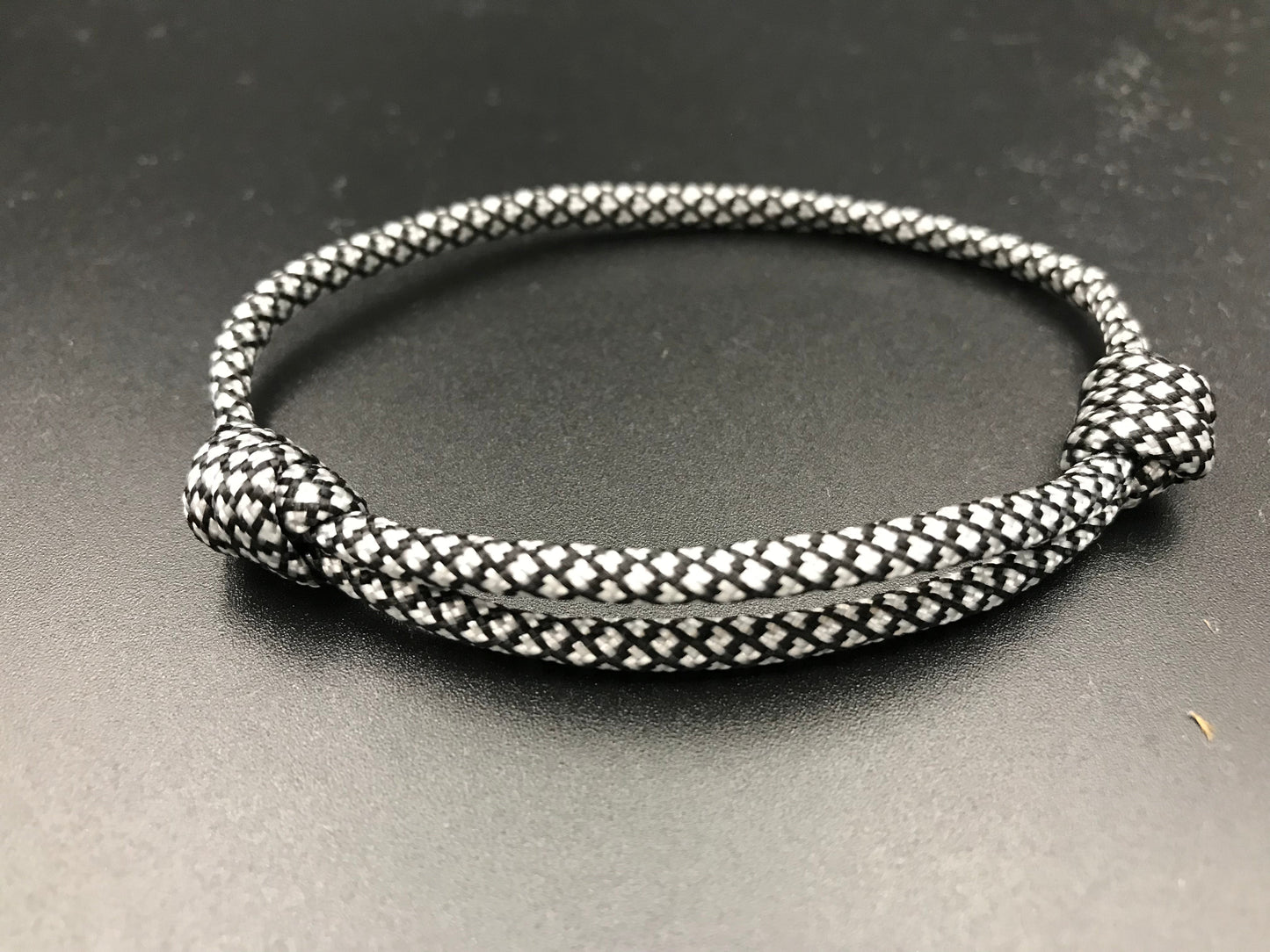 Paracord friendship bracelet in silver with black diamond pattern lightweight and fully adjustable