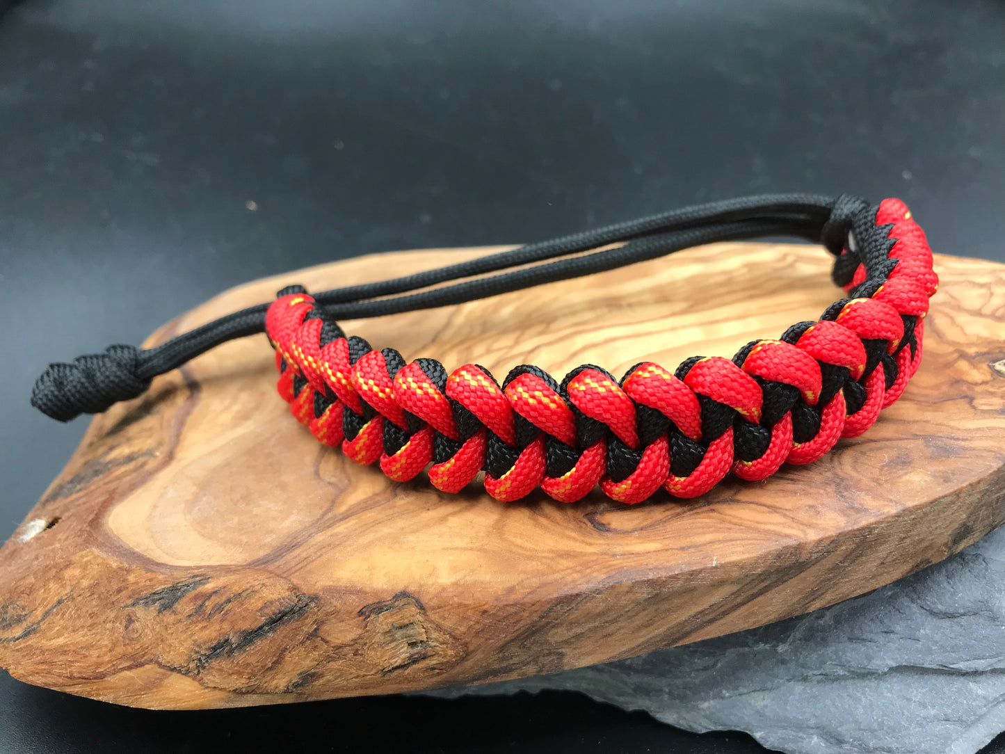 Paracord survival bracelet hand made lightweight and in black and pheonix Red ( red with yellow) coloured Paracord U.K.