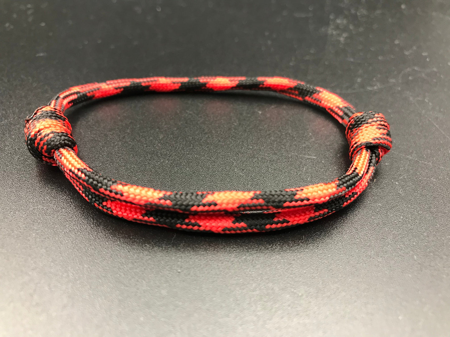 Friendship bracelet in Red Devil. Red black mix lightweight and adjustable