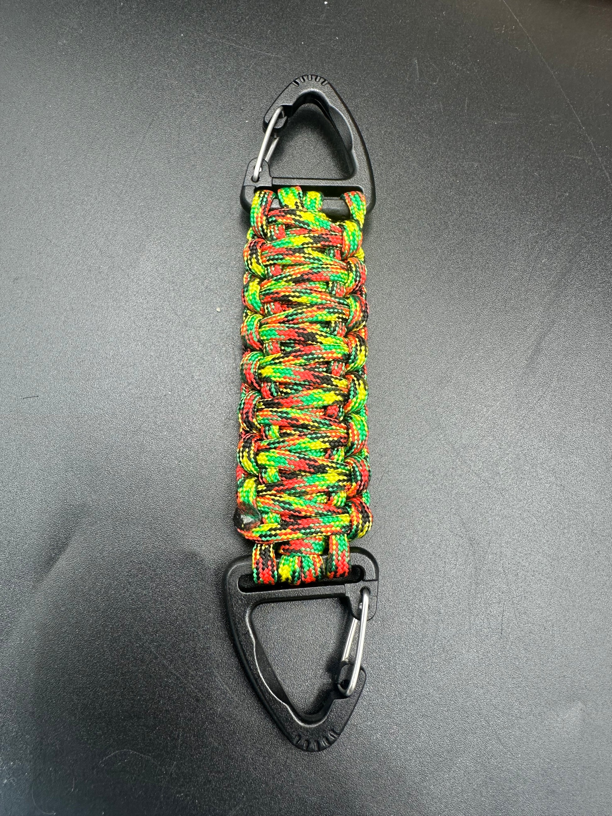 Our Tactical double ended triangle clip with a beautiful Paracord king cobra woven centre, are designed for your EDCs, molle, army bags and other field Attachments, handmade in this themed Caribbean camouflaged colour