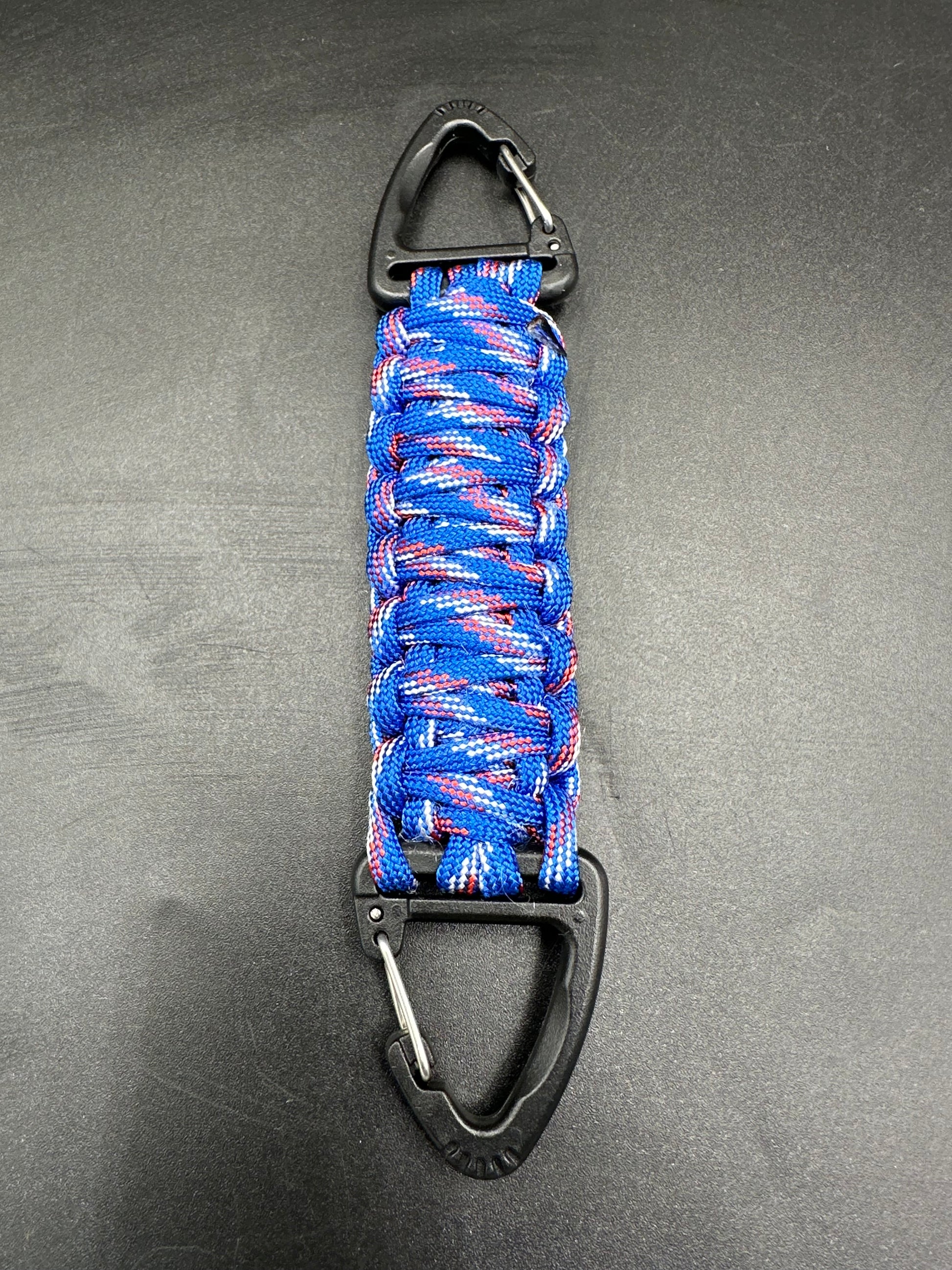 Our Tactical double ended triangle clip with a beautiful Paracord king cobra woven centre, are designed for your EDCs, molle, army bags and other field Attachments, handmade in this Patriot blue (blue white red) themed colour