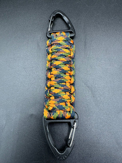Our Tactical double ended triangle clip with a beautiful Paracord king cobra woven centre, are designed for your EDCs, molle, army bags and other field Attachments, handmade in this orange jungle camouflaged (orange black yellow) colours