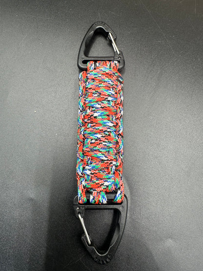 Our Tactical double ended triangle clip with a beautiful Paracord king cobra woven centre, are designed for your EDCs, molle, army bags and other field Attachments, handmade in this Urban Graffiti camouflage (red light blue greens whites) colour