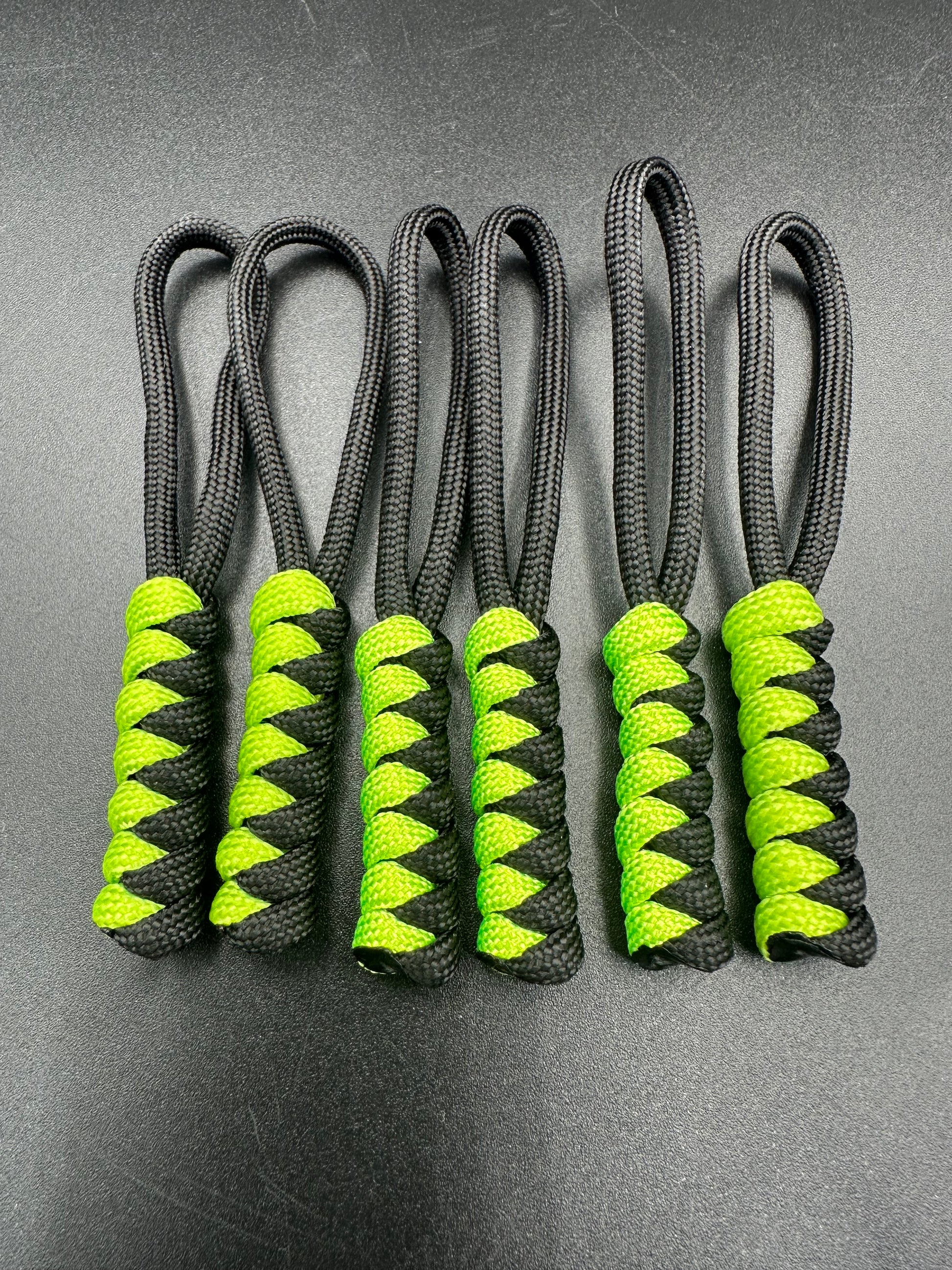 Paracord zip pulls in a Halloween themed black & Neon Green 
Sold as a 6 pack theses are light weight, strong and all handmade in our U.K. store