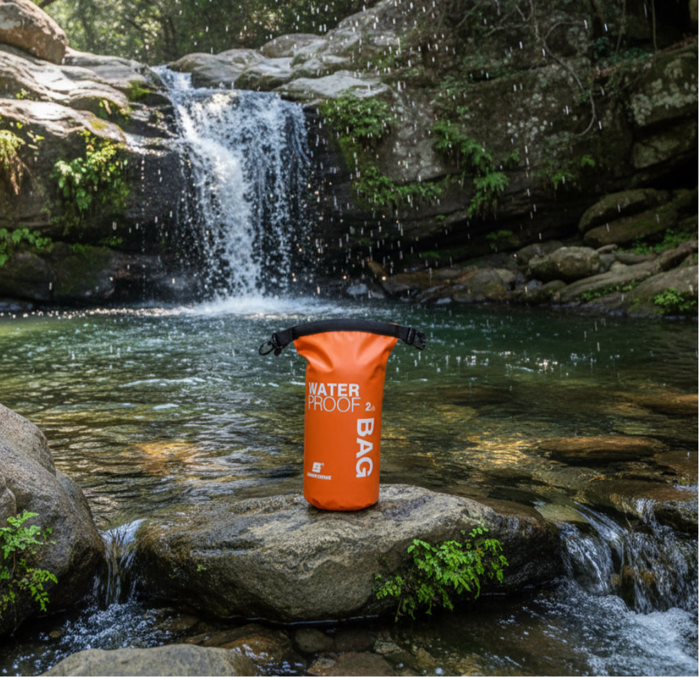 2 litre dry bag waterproof storage in orange by a rock pool waterfall hiking gear