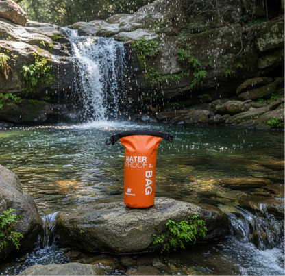 2 litre dry bag waterproof storage in orange by a rock pool waterfall hiking gear