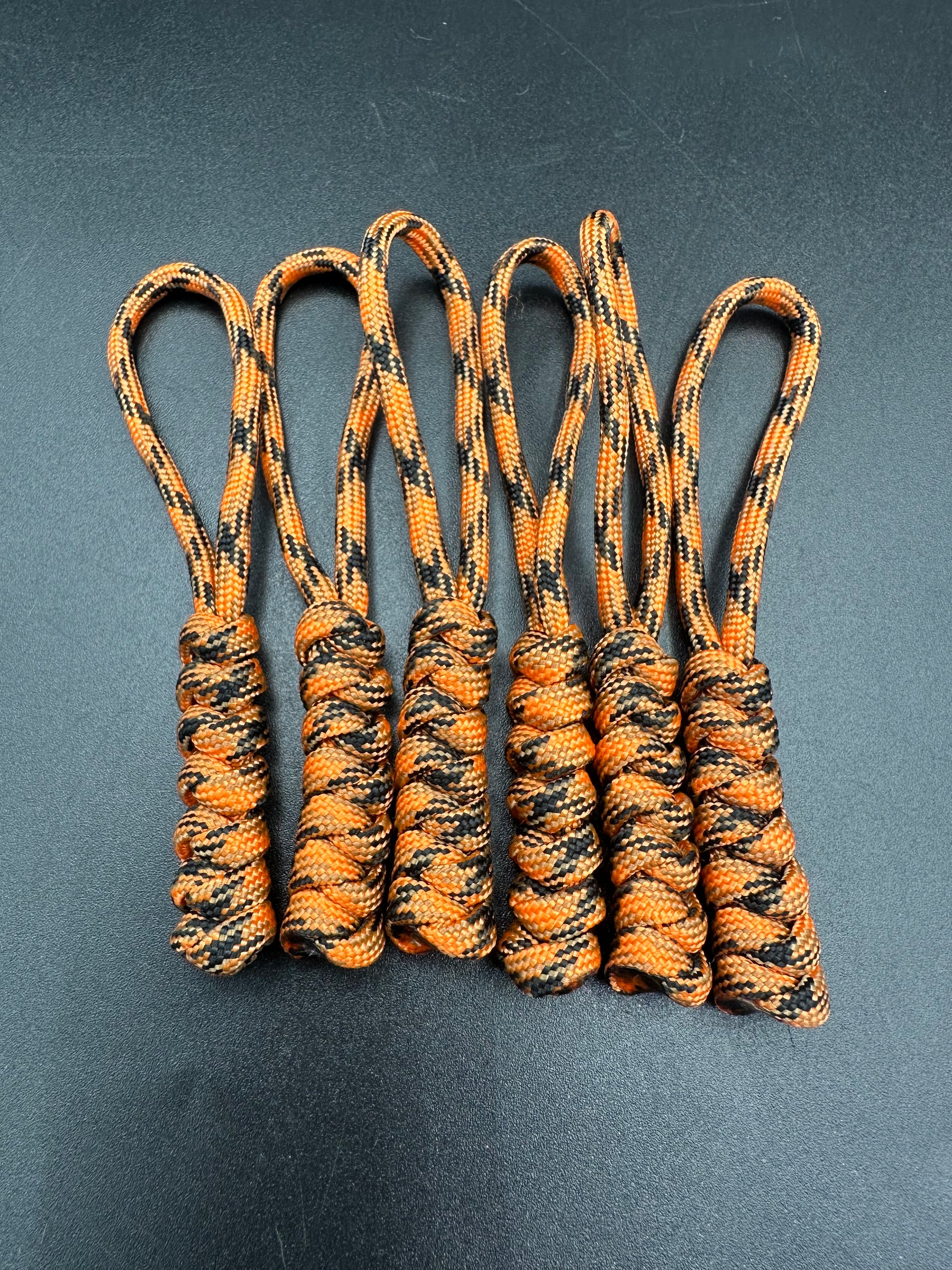 Paracord zip pulls in a Halloween themed pumpkin orange (black orange mix)
Sold as a 6 pack theses are light weight, strong and all handmade in our U.K. store