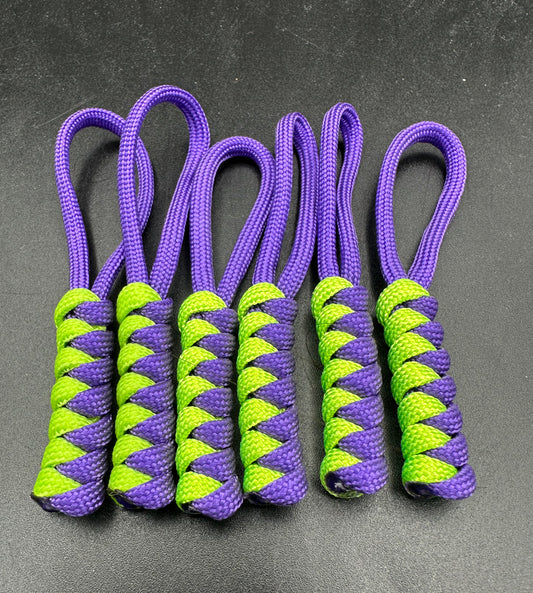 Paracord zip pulls in a Halloween themed purple and Neon Green 
Sold as a 6 pack theses are light weight, strong and all handmade in our U.K. store