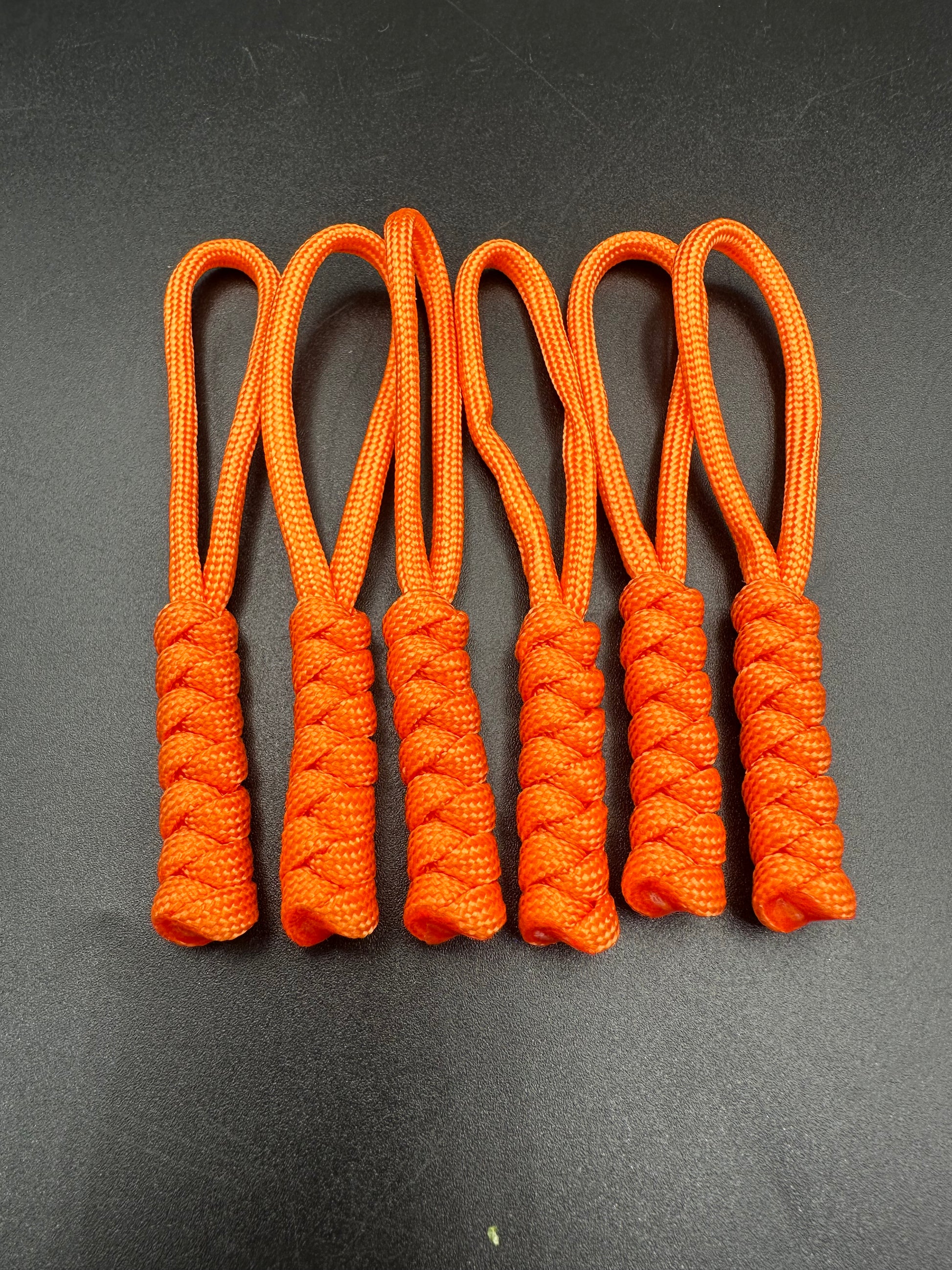 Paracord zip pulls in a Halloween themed bright orange 
Sold as a 6 pack theses are light weight, strong and all handmade in our U.K. store