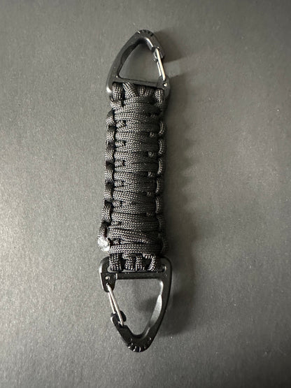 Our Tactical double ended triangle clip with a beautiful Paracord king cobra woven centre, are designed for your EDCs, molle, army bags and other field Attachments, handmade in this bold black colour