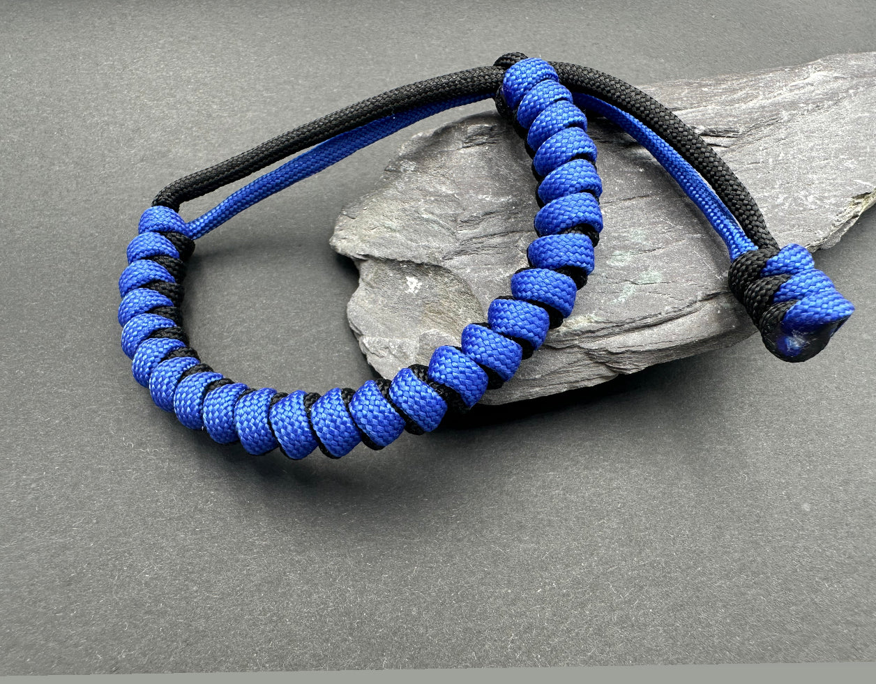 Paracord survival bracelets in a Black & Royal blue colour, item is lightweight comfortable and handmade in a snake knott design U.K.