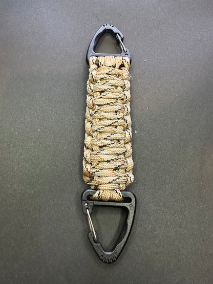 Our Tactical double ended triangle clip with a beautiful Paracord king cobra woven centre, are designed for your EDCs, molle, army bags and other field Attachments, handmade in this Desert camouflaged colour
