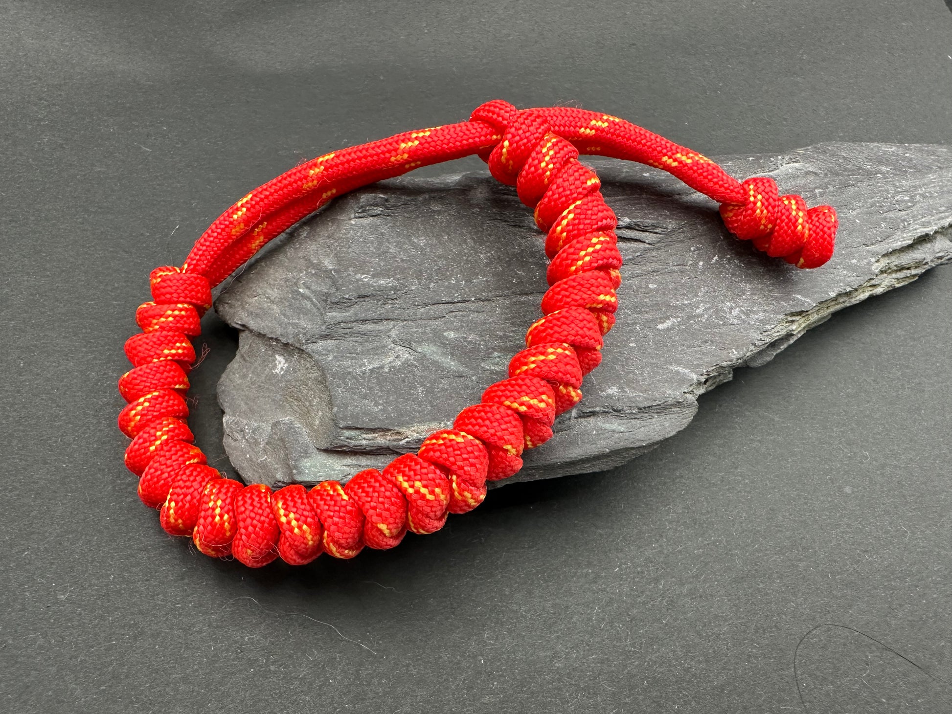 Paracord survival bracelets in the Pheonix red colour (red with yellow flecks) the item is lightweight comfortable and handmade in a snake knott tactical design U.K.
