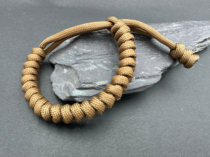 Paracord survival bracelets in Army Kaki brown colour. the item is lightweight comfortable and handmade in a snake knott tactical design U.K.