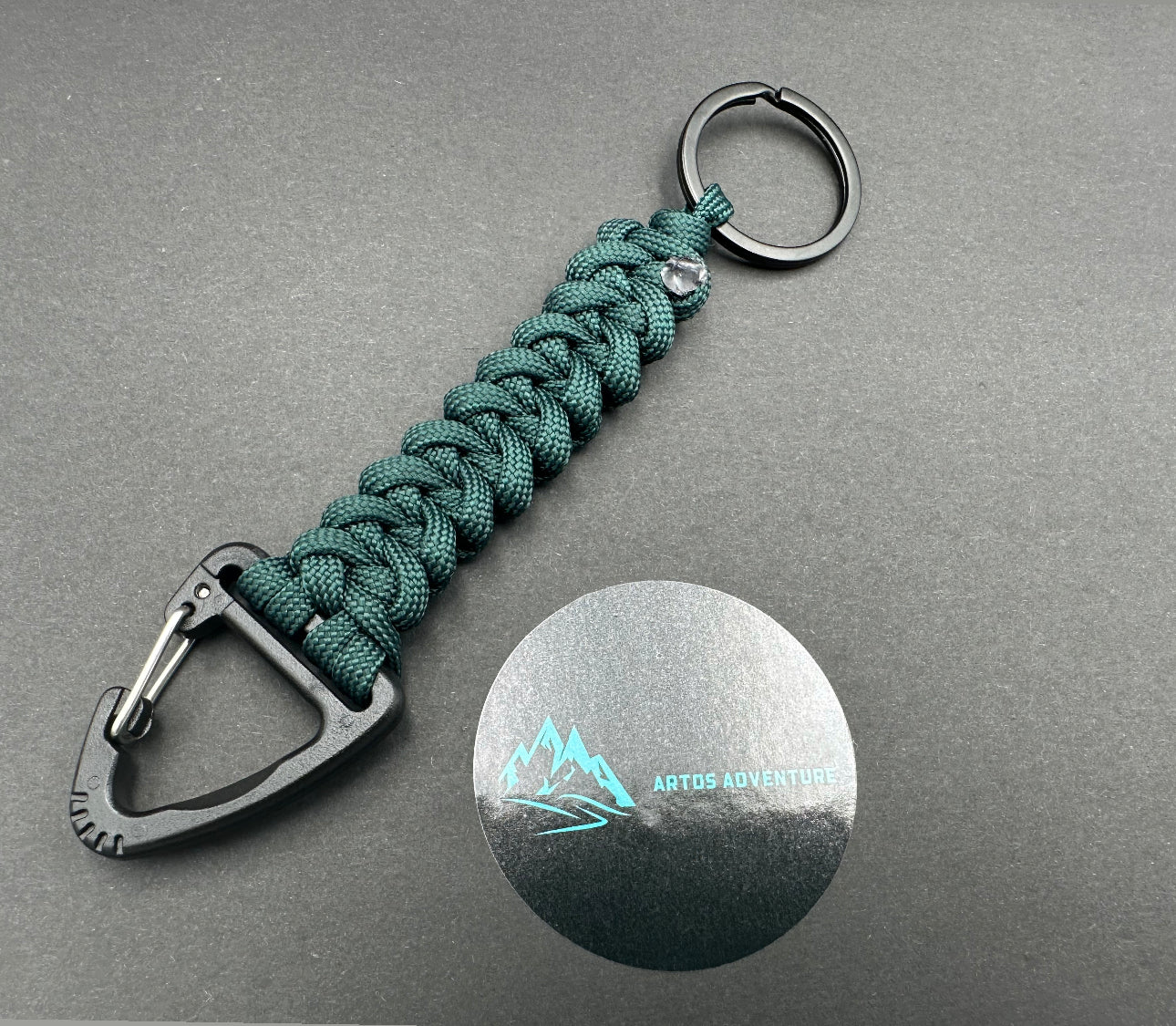Tactical EDC Paracord keyring with a triangle clip and split ring, made in Emerald green coloured shark jaw weave 