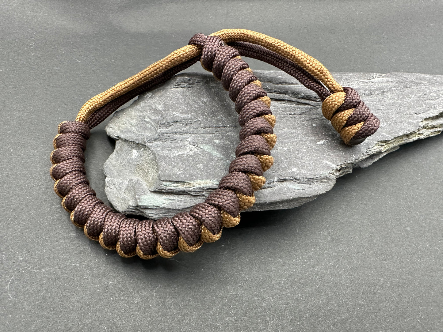 Paracord survival bracelets chocolate brownie and Kaki brown colour, the item is lightweight comfortable and handmade in a snake knott tactical design U.K.