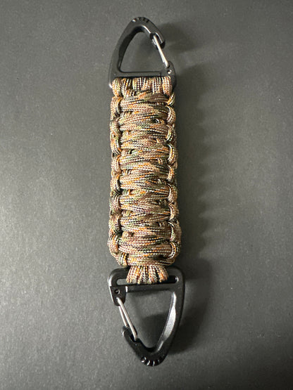 Our Tactical double ended triangle clip with a beautiful Paracord king cobra woven centre, are designed for your EDCs, molle, army bags and other field Attachments, handmade in this Autumn woodland camouflaged colour