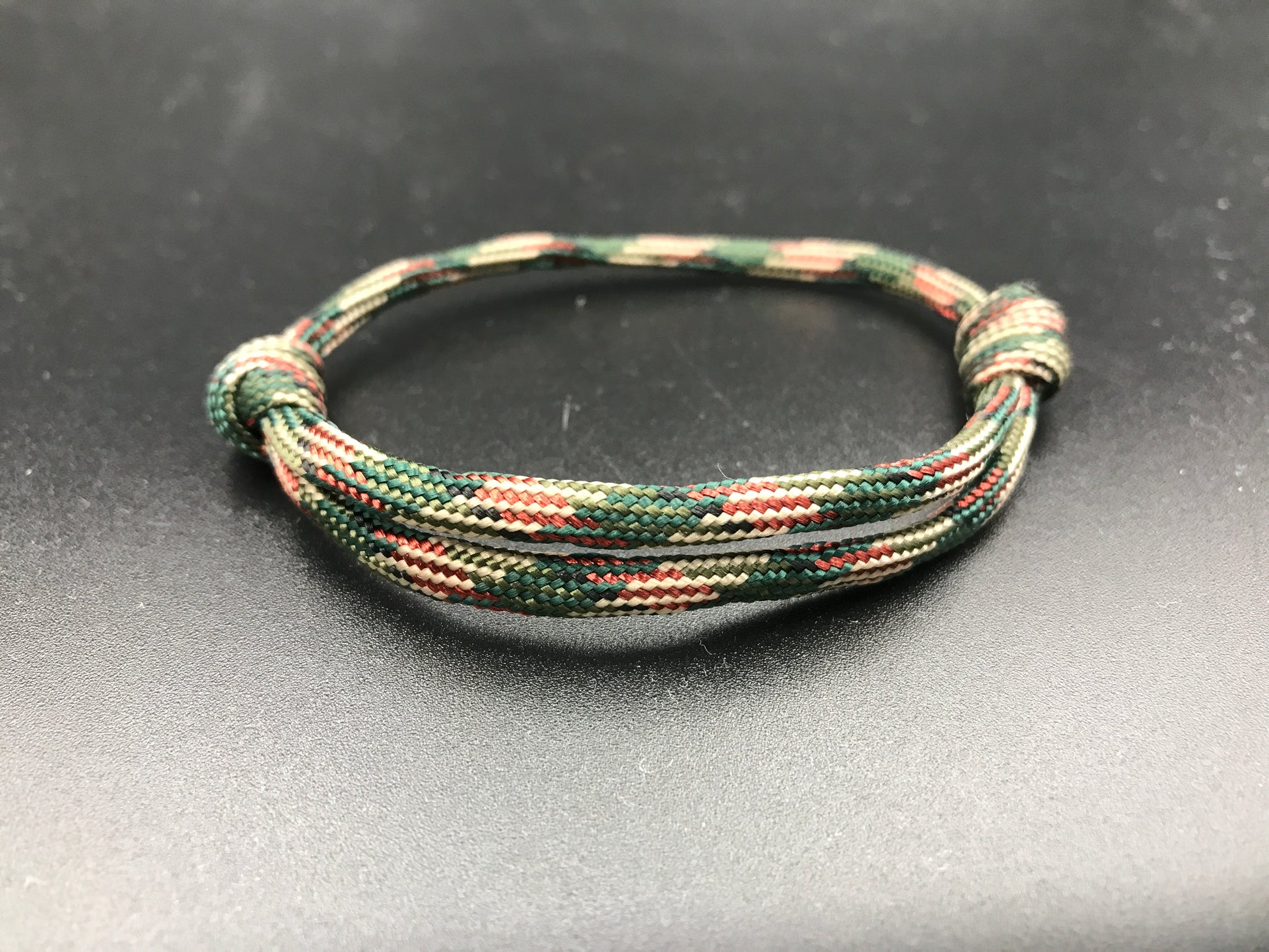 Paracord friendship bracelet in red green camo lightweight and adjustable 