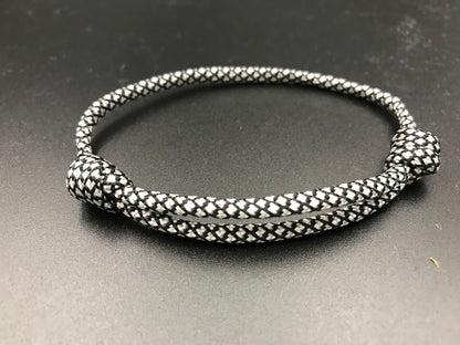 Paracord friendship bracelet in silver with black diamond pattern lightweight and fully adjustable 