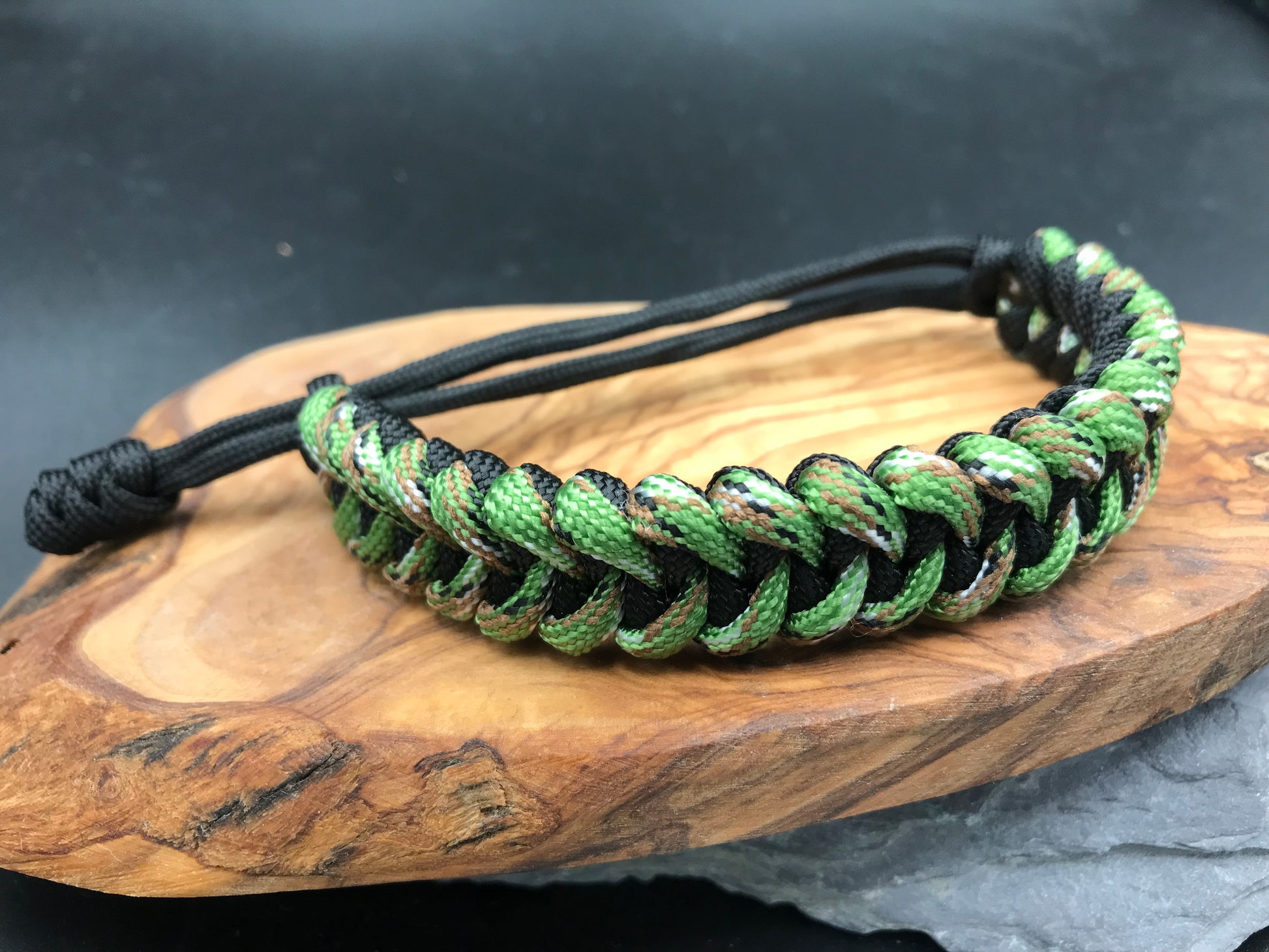Paracord survival bracelet hand made lightweight and in black and forest green camo coloured Paracord U.K. 
