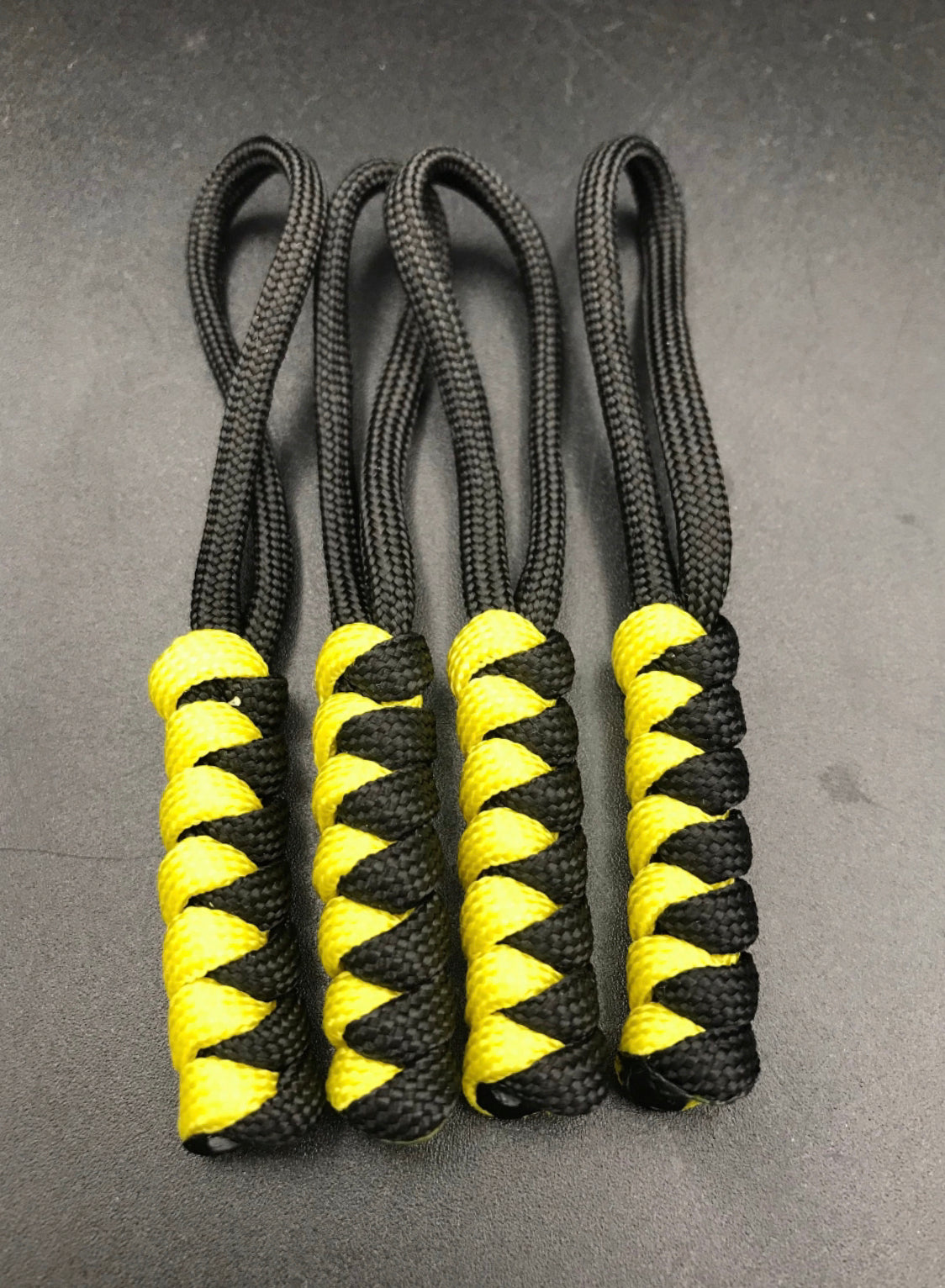 Paracord zip pulls in  black and yellow (4 pack) light weight and strong, handmade in U.K
