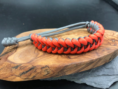 Paracord survival bracelet hand made lightweight and in grey and neon orange coloured Paracord U.K. 