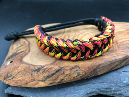 Paracord survival bracelet hand made lightweight and in black and fireball coloured Paracord 