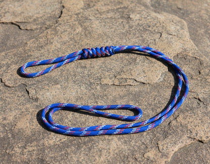 Blue and red rope on a textured stone surface