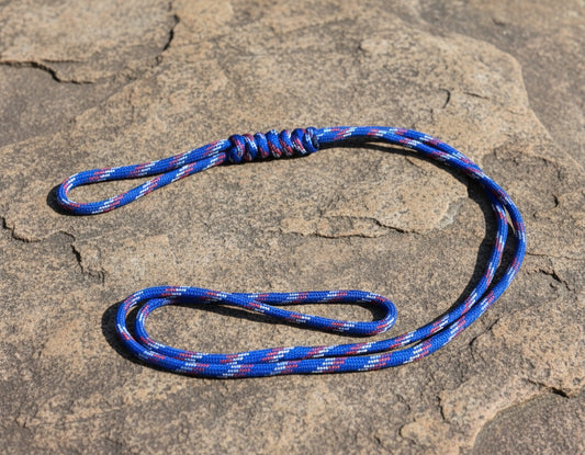 Blue and red rope on a textured stone surface