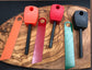 Fire steel fire starter product range in three colours orange, red , black/green
