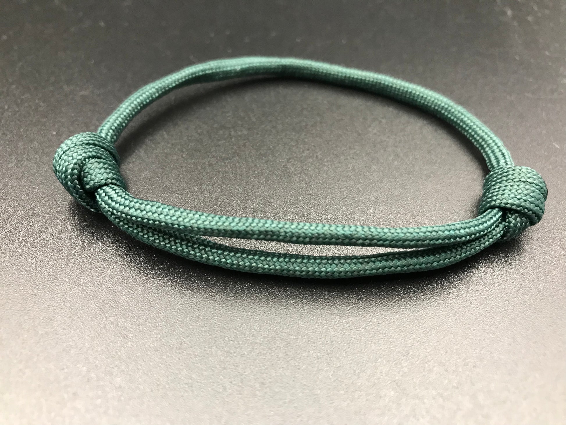 Paracord friendship bracelet in Dark emerald green light weight and fully adjustable 