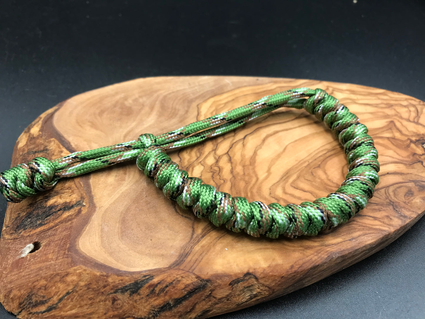Paracord Bracelet in a forest green camo snake knott design made in the U.K to be lightweight strong and fully adjustable 